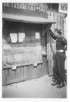 Roy Dutton reading bulletin board at Stalag Luft I 1945